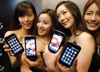 File photograph of models posing with the new Samsung Galaxy S Android smartphone during its launch ceremony at the headquarters of Samsung Electronics in Seoul